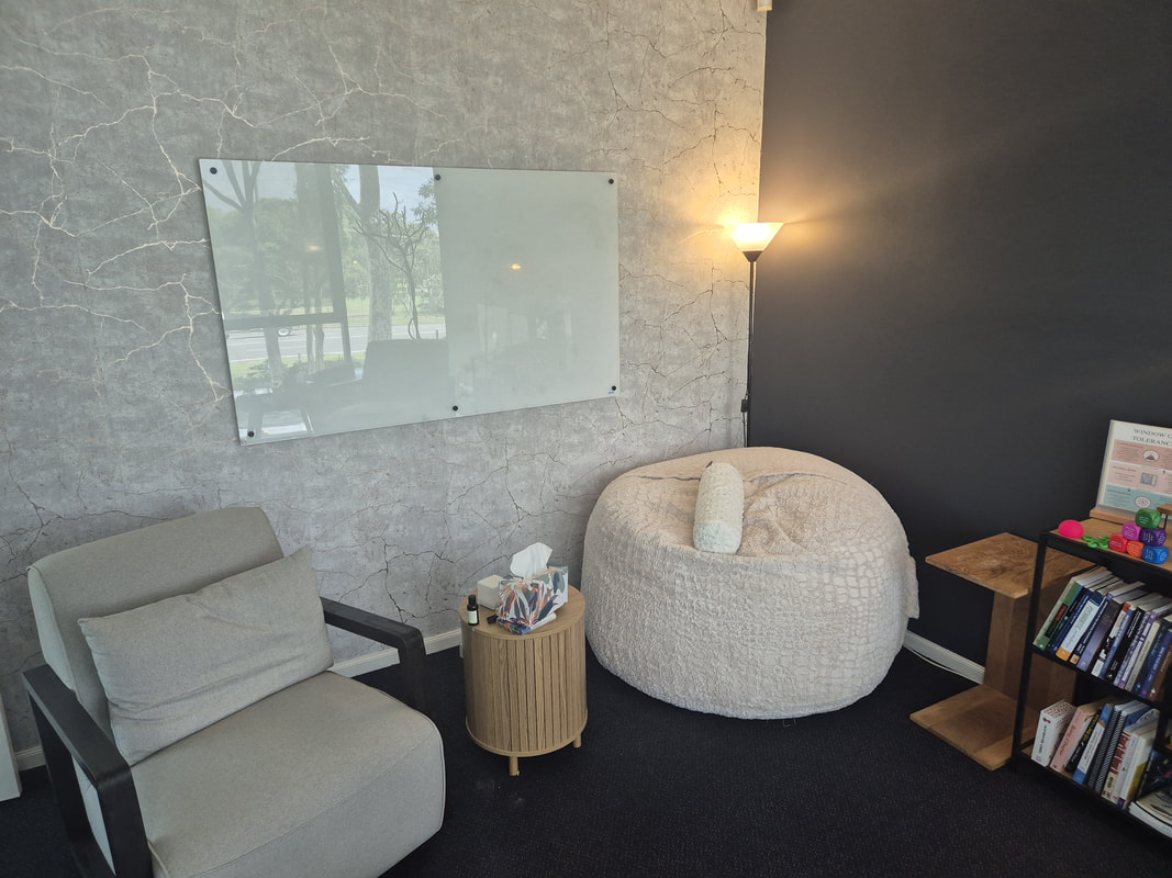 This picture shows Belinda's therapeutic room set-up. The armchair pictured on the left is typically where Belinda would be seated. The armchair closest to the window is where the client would typically be seated. The therapy pod is often used by adolescent and adult clients.